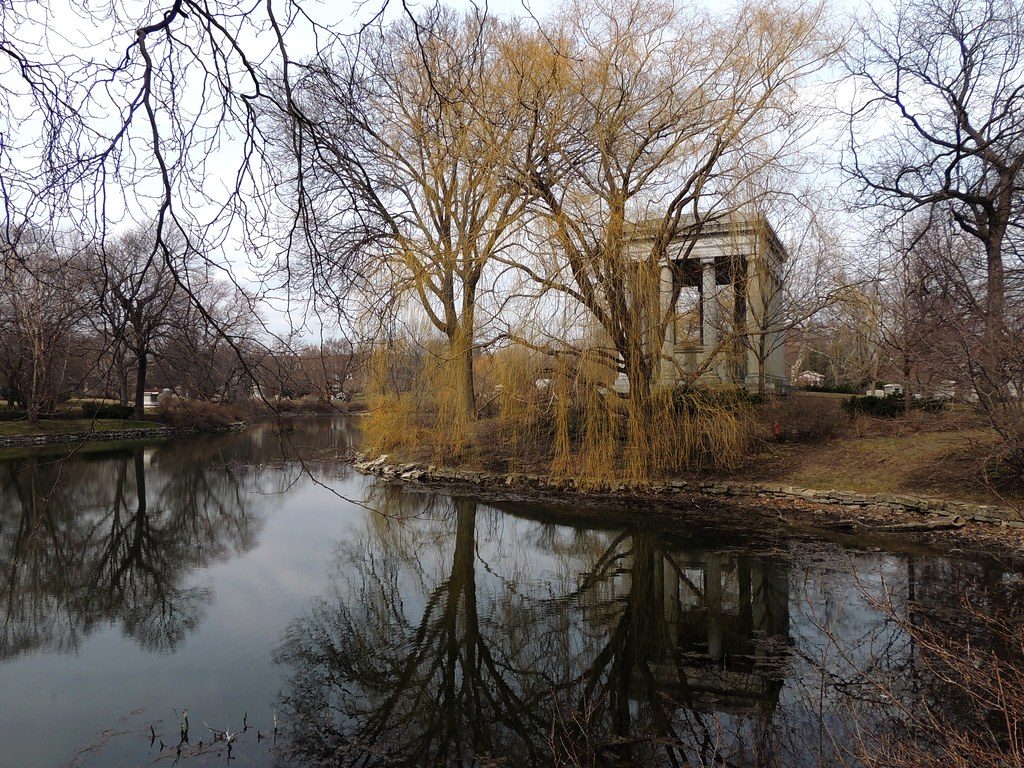 photo shows a peaceful pond in graceland cemetery on an autumn day